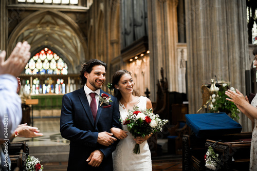 Newly wed couple walking down the aisle