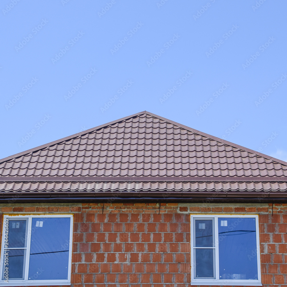 The house with plastic windows and a roof of corrugated sheet