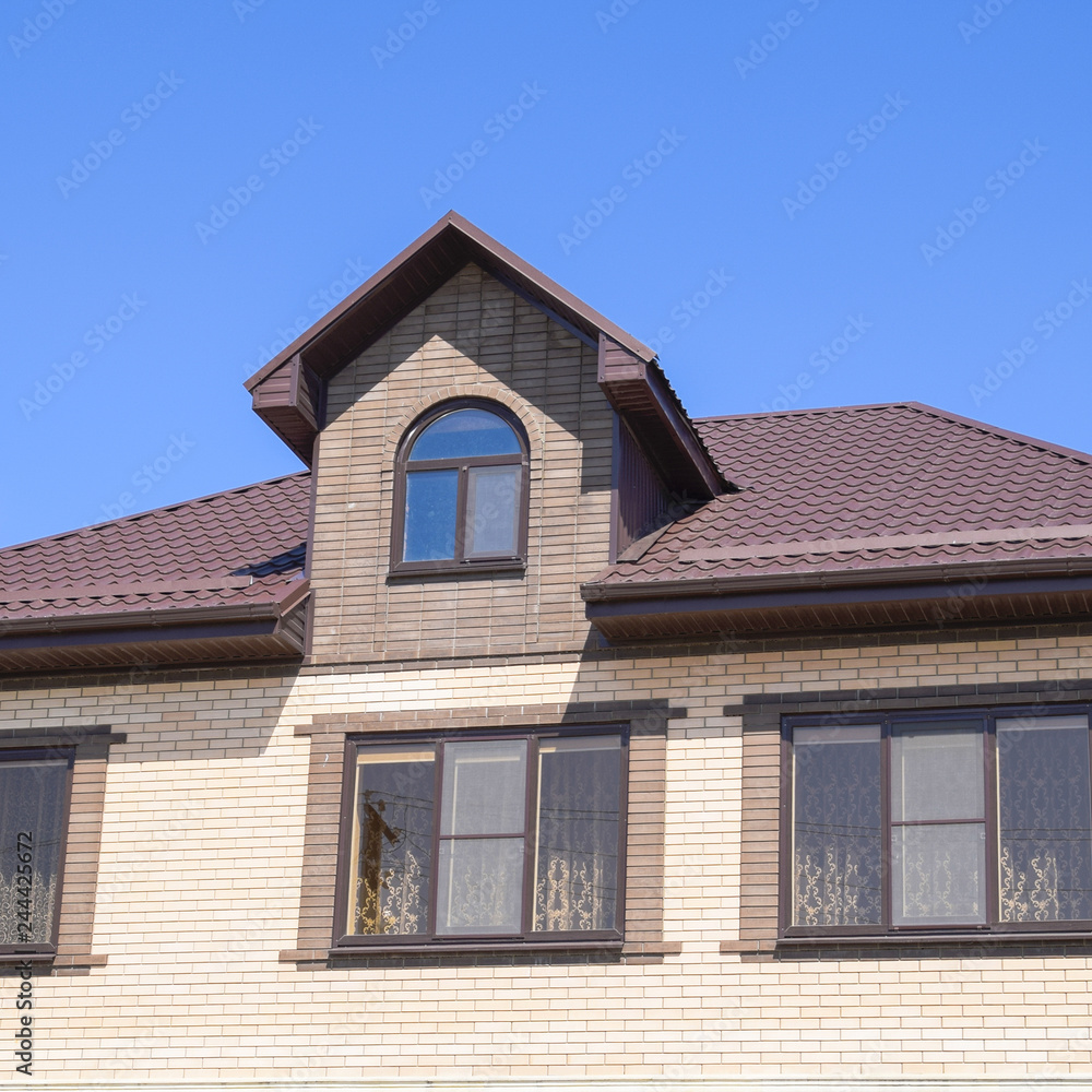 The house with plastic windows and a roof of corrugated sheet