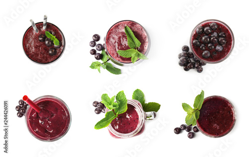 Set of delicious acai juice in different glassware on white background  top view