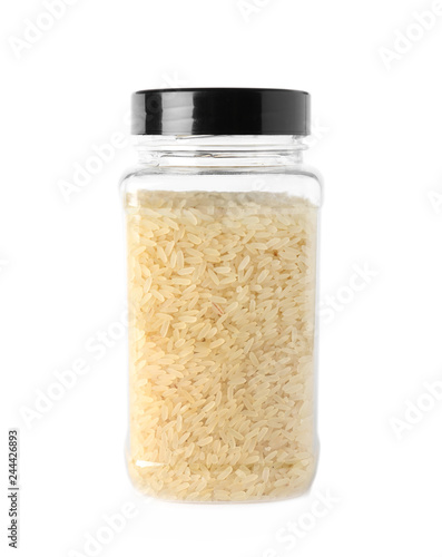 Jar with uncooked parboiled rice on white background