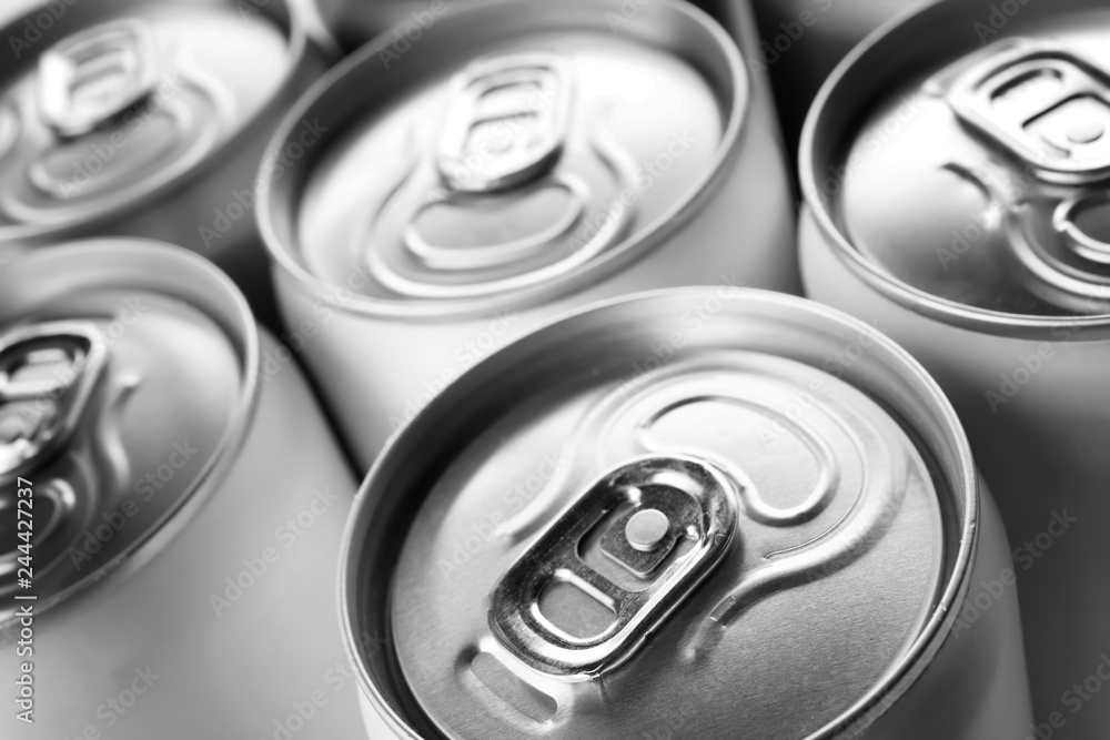 Aluminum cans with cold beverage as background, closeup Aluminum cans with cold beverage as background, closeup