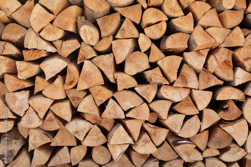 Stacked firewood as background. Heating house in winter Stacked firewood as background. Heating house in winter