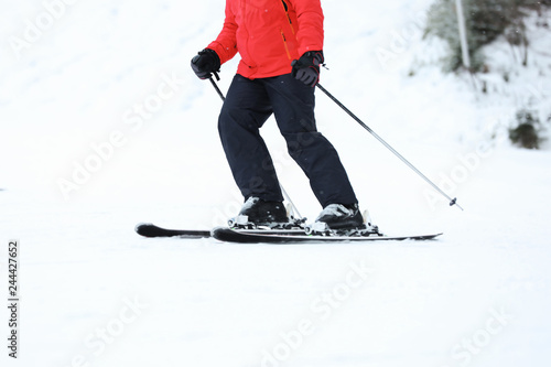 Skier on slope at resort, closeup. Winter vacation