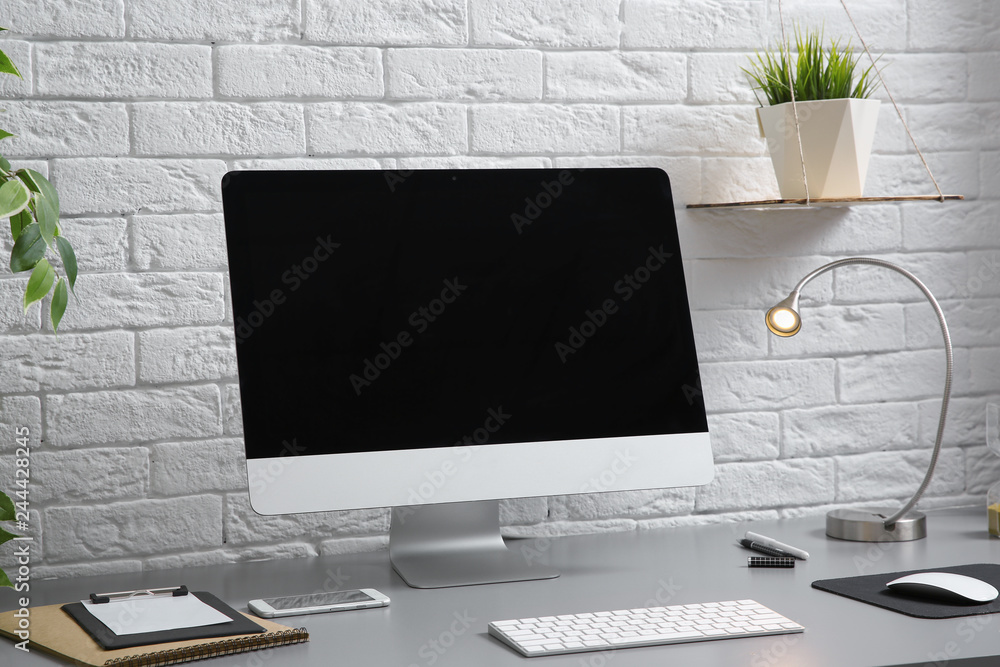 Fototapeta premium Interior of comfortable work place with computer on table at home