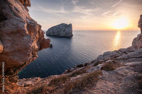 Sardinia, Alghero, Capo Caccia. Famous tourist destination. Amazing sunset reflected on the sea seen from the cliff. Relaxation concept