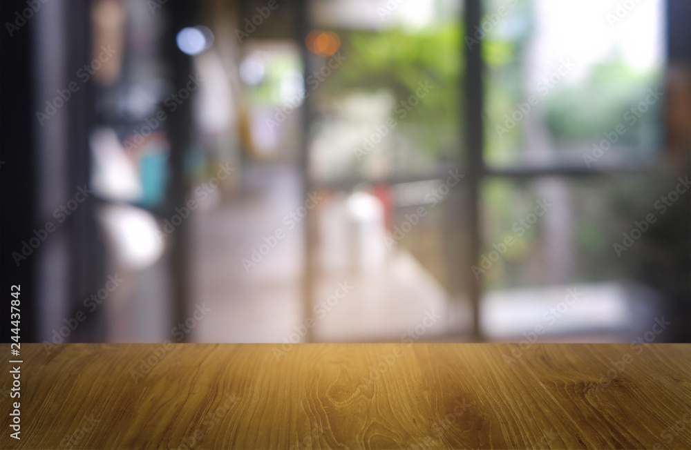 Empty dark wooden table in front of abstract blurred background of restaurant, cafe and coffee shop interior. can be used for display or montage your products - Image. Empty dark wooden table in front of abstract blurred background of restaurant, cafe and coffee shop interior. can be used for display or montage your products - Image.