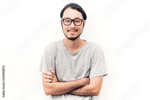 Portrait of a asian young handsome man while standing isiolated on white background