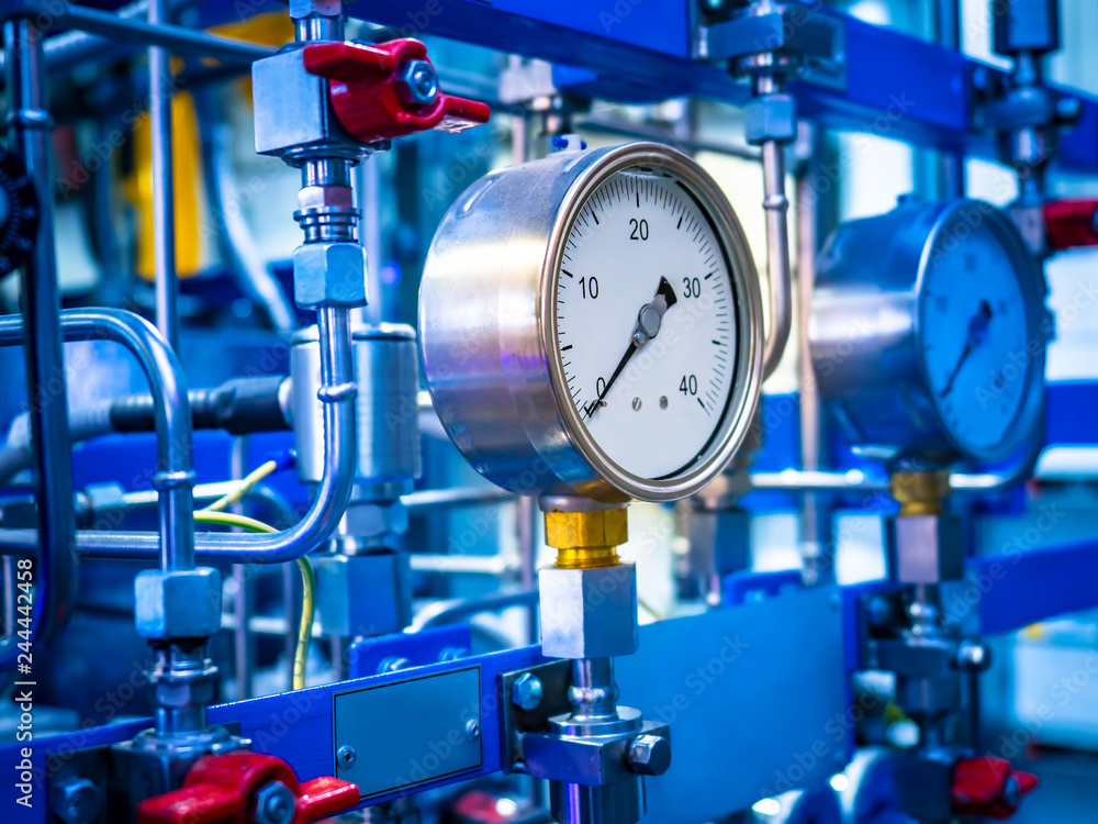Pressure gauge. Industrial concept. Sensors on the pipes. Red valve on the pipe. Fragment of industrial apparatus. Pressure gauge. Industrial concept. Sensors on the pipes. Red valve on the pipe. Fragment of industrial apparatus.