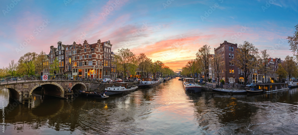 Amsterdam Netherlands, sunset panorama city skyline at canal waterfront