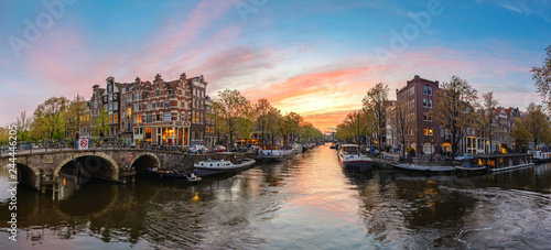 Amsterdam Netherlands, sunset panorama city skyline at canal waterfront