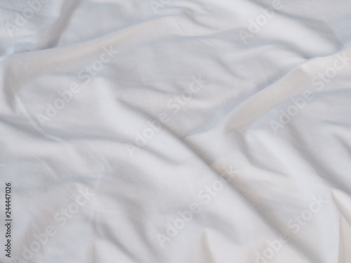 crumpled white bedsheet surface