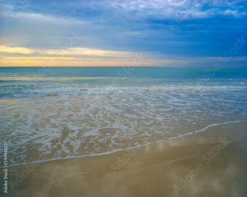 Dawn or dusk over a pastel colored seashore