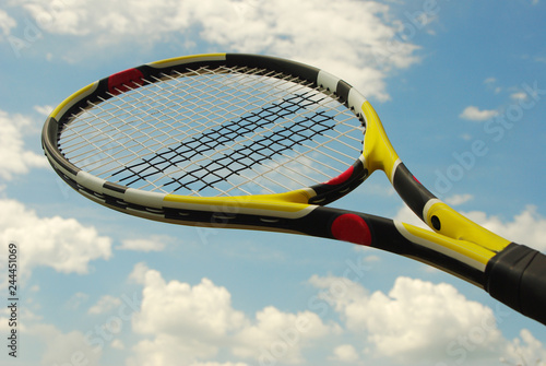 Tennis racket against the sky.