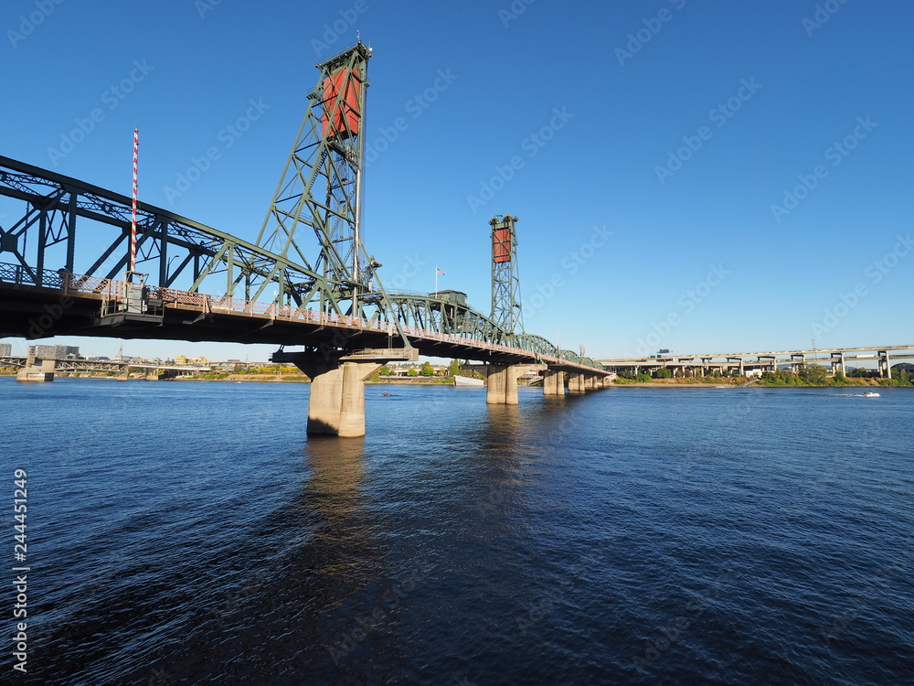 The Hawthorne Bridge over the Willamette River in Portland, Oregon, on a clear, cloudless autumn afternoon.