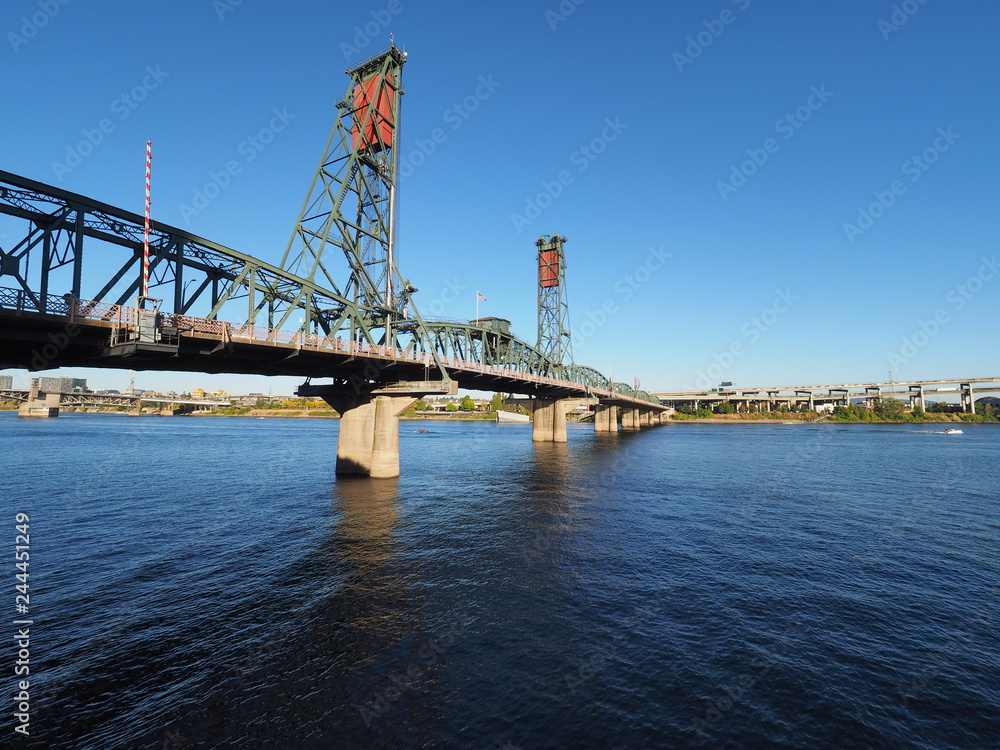 The Hawthorne Bridge over the Willamette River in Portland, Oregon, on a clear, cloudless autumn afternoon. The Hawthorne Bridge over the Willamette River in Portland, Oregon, on a clear, cloudless autumn afternoon.
