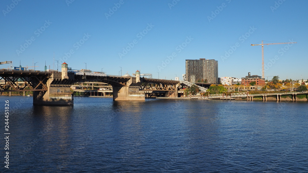 The Burnside Bridge over the Willamette River in Portland, Oregon, on a clear and cloudless autumn afternoon.