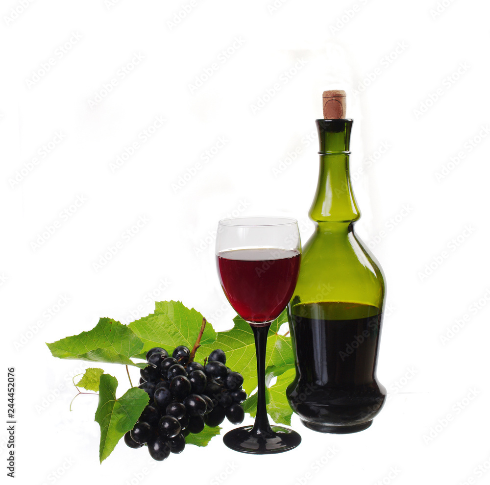 A glass of red wine, a bottle and a bunch of grapes. Isolated on white