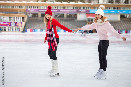 women ice skating outdoor at ice rink