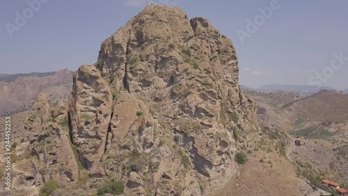 4k drone aerial footage of the small village of Pentedattilo, Calabria, Italy, with church and ruins of the abandoned village, Greek colony on Mount Calvario, which form recalls the five fingers