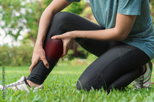 Young woman asian have accident leg twist sprain in sport exercise jogging, Selective focus, Exercise and healthy concept.