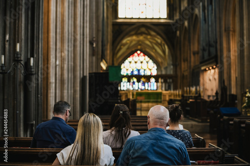 Fototapeta Churchgoers sitting in the pew