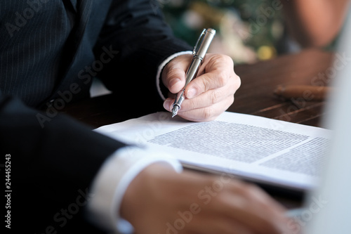 Bild auf Leinwand Legal counsel presents to the client a signed contract with gavel and legal law