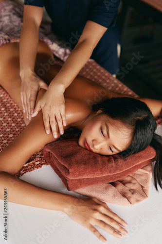 Thai Massage. Woman Having Relaxation Back Massage At Spa Salon