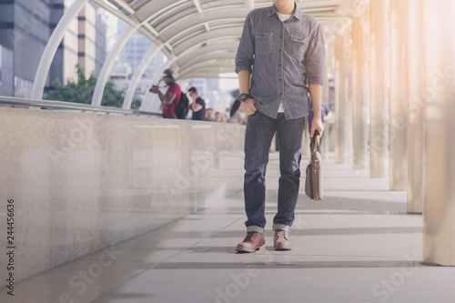 Male walking in city.