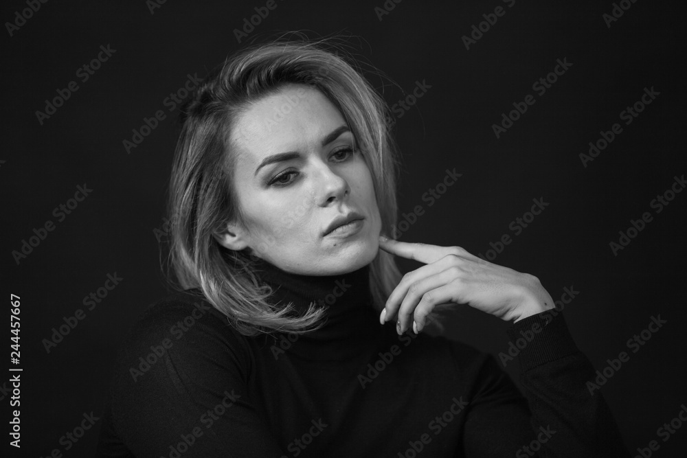 Dramatic black and white portrait of a beautiful woman on a dark background Dramatic black and white portrait of a beautiful woman on a dark background