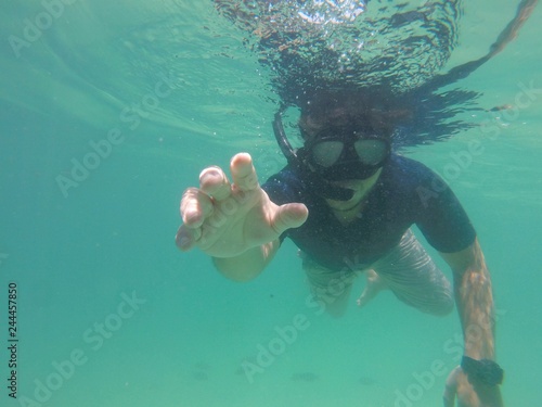 Young man snorkeling in a sea