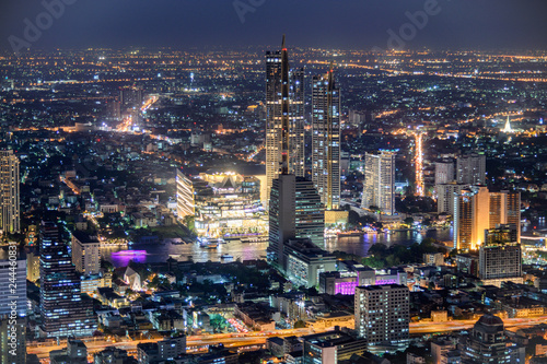 Cityscape of illuminated building with department store near Chao Phraya river