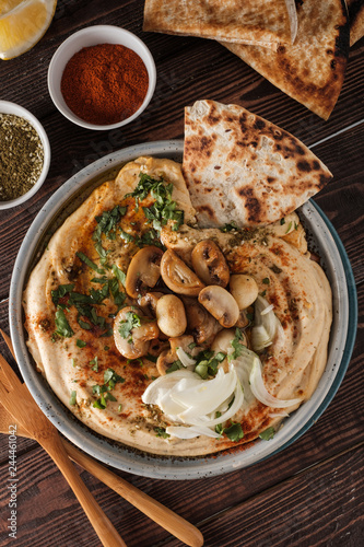 Traditional Mediterranean hummus with mushrooms and onions. Classic Hummus with paprika, olive oil, onions, mushrooms and seasonings