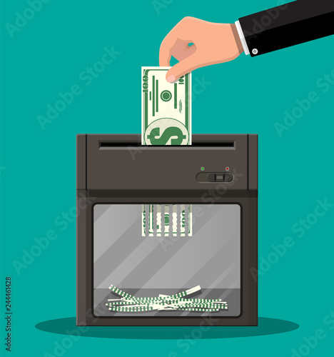 Hand putting dollar banknote in shredder machine