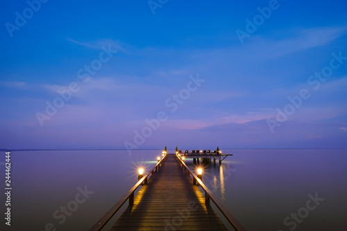 Beautiful jetty walkway on the sea in twilight time. © Maicyber