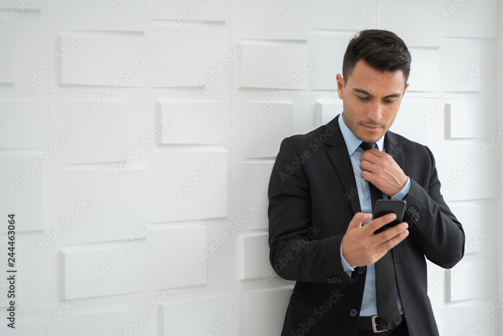 Portrait of confident Businessman is using cell phone. Portrait of confident Businessman is using cell phone.