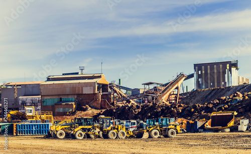 Wheel loaders and other mining machines parked next to the old mining buildings