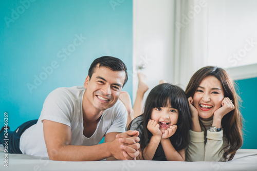 Portrait happy Asian family over blue background