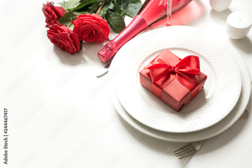 Valentine's day or birthday dinner. Elegance table setting with champagne and red rose. Valentine's day or birthday dinner. Elegance table setting with champagne and red rose.