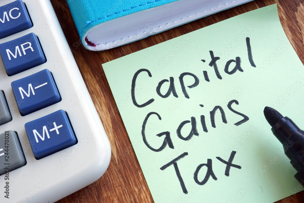 CGT Capital Gains Tax. Memo stick and calculator. Stock Photo | Adobe Stock