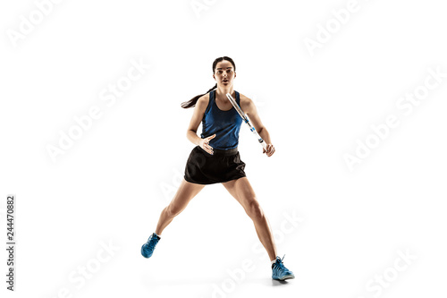 Full length portrait of young woman playing tennis isolated on white background. Healthy lifestyle. The practicing, fitness, sport, exercise concept. The female model in motion or movement