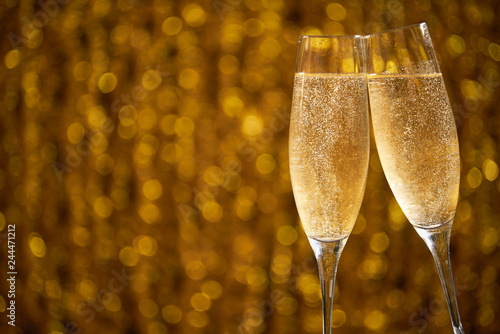 Two glasses of champagne on shiny bokeh effects for a wedding