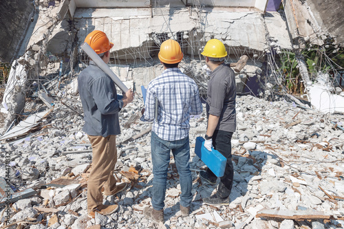 Engineer architect and worker operation control demolish old building.