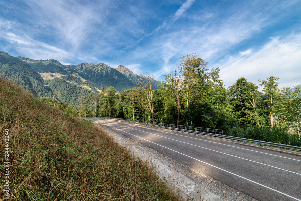 Fototapeta premium Road to the mountains. Sunny morning.