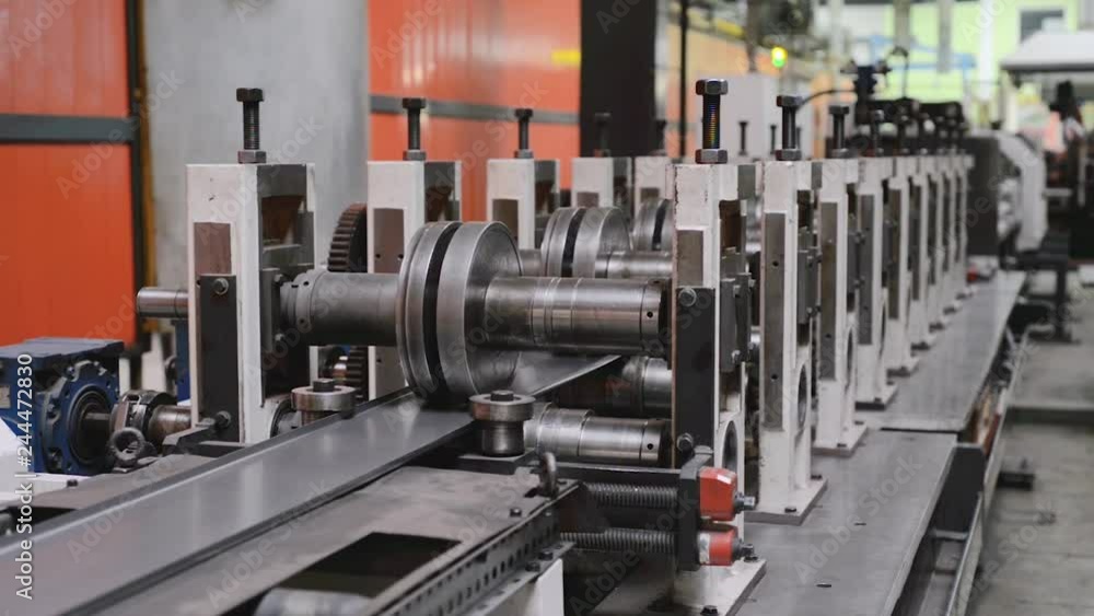 Roller forming machine. The interior of the plant producing a metal profile. Roller forming machine. The interior of the plant producing a metal profile.