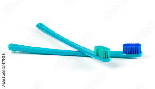 Two beautiful blue toothbrushes. Close up. Isolated on white background