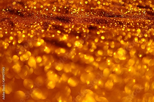 shiny brassy sand made of glitters - bright concept with bokeh texture - beautiful abstract photo background