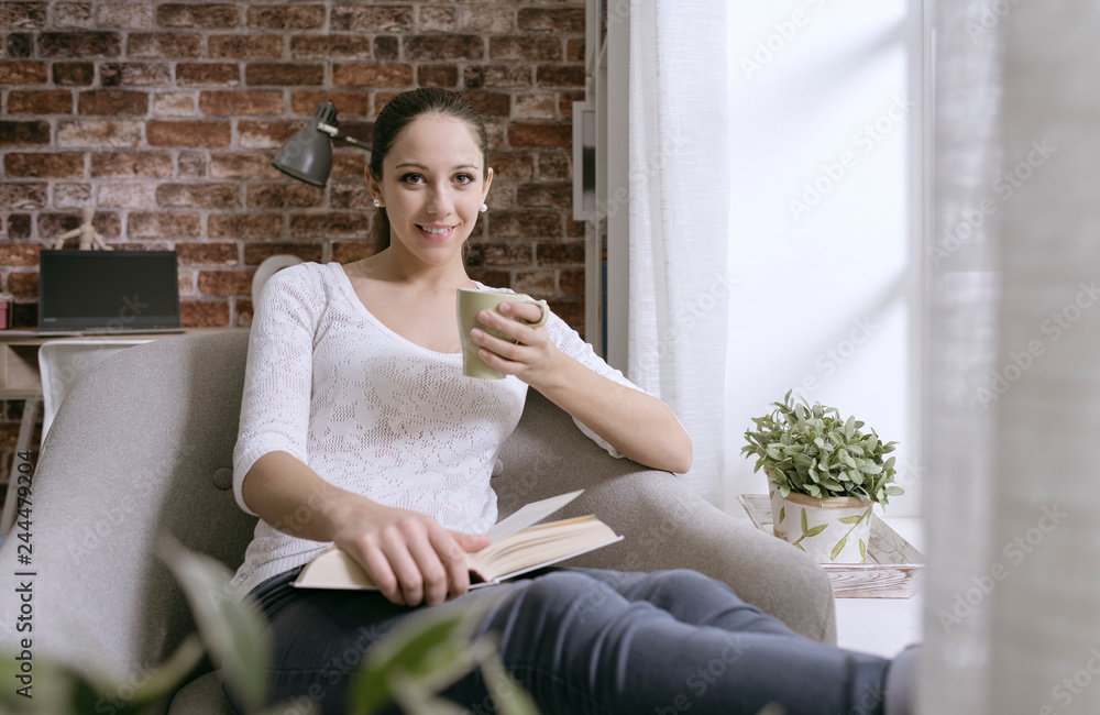 Woman having a coffee break and reading