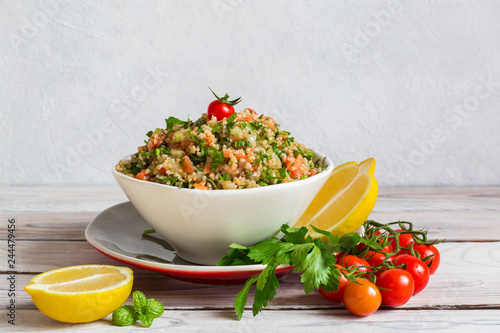 Tabbouleh - is a Levantine vegetarian salad made of chopped parsley, with tomatoes, mint, onion and bulgur, and seasoned with olive oil, lemon juice.