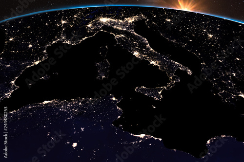 Earth night light at central Europe. Italy close up view. Sunshine from space. Elements of this image furnished by NASA.